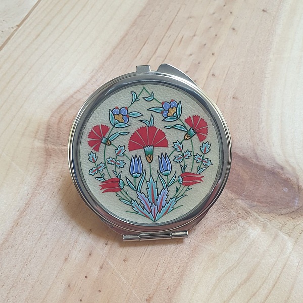 Miroir de sac rond avec enluminure florale style ottoman.