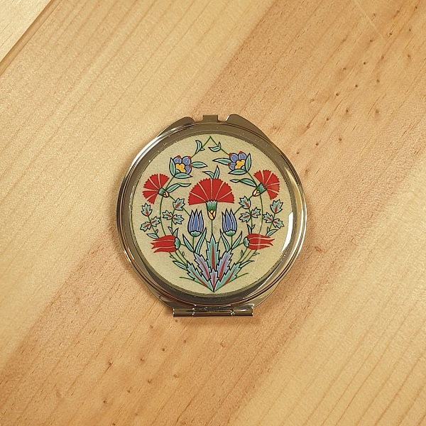 Miroir de sac rond avec enluminure florale style ottoman.